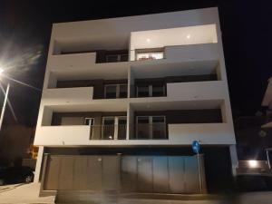 a tall white building with a pool in front of it at Suite Exclusive a due passi dal mare posto auto in San Benedetto del Tronto