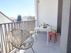 a balcony with a white table and a chair at Suite Exclusive a due passi dal mare posto auto in San Benedetto del Tronto