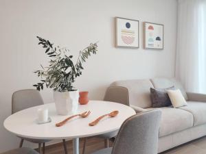 a living room with a white table and a couch at Suite Exclusive a due passi dal mare posto auto in San Benedetto del Tronto +40 photos