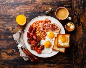 a plate of breakfast food with eggs bacon beans and toast at The County Hotel in Carlisle +60 photos