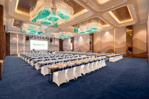 a large room with rows of tables and chairs at Wyndham Garden Sonasea Van Don in Ha Long