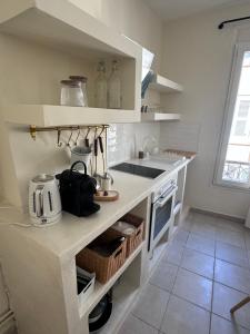 a kitchen with a sink and a counter top at Appartement Lemaitre in Marseille