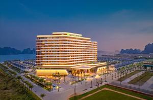 a large hotel building with a park in front of it at Wyndham Garden Sonasea Van Don in Ha Long