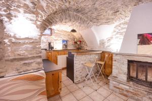 una cocina con una pared de piedra en un castillo en Le Chalet du Villard, en Saint-André