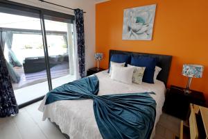 a bedroom with a bed with a large window at Casa da Calheta in Maia +32 photos