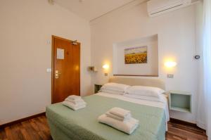 sypialnia z łóżkiem z dwoma ręcznikami w obiekcie Hotel Del Buono Wellness & Medical Spa w mieście Chianciano Terme