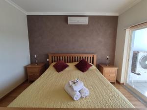 a bedroom with a bed with towels on it at 3Z Brisa Mar - Casas & Papéis in Armação de Pêra +10 photos