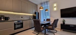 a kitchen with a table and chairs and a television at La Casa Allegra in Opatija +72 photos