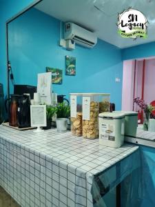 a counter in a restaurant with a blue wall at Hotel SN Legacy in Kuala Terengganu