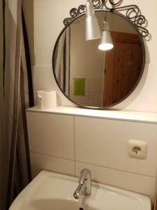 a bathroom with a mirror above a sink at Ferienhof - Rauhenberg in Wangels