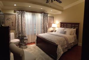 a bedroom with a large bed and a window at Louisiana Cajun Mansion in Youngsville