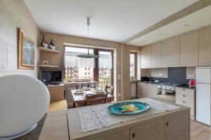 a kitchen with a table with a plate on it at Appartamento Merida6 - Asiago in Asiago