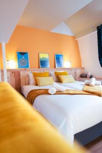 a group of four beds in a room at Lets Relax - Coté Soleil Levant in Mons