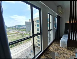 a room with a window with a view of a building at Kk homeStay City suites Room Ming Garden Residence in Kota Kinabalu