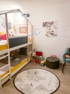 a bedroom with a bunk bed and a carpet at Comme une maison à Paris in Paris