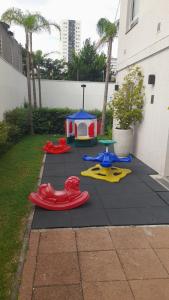 a pretend play area with a play house and a playground at All Liberdade (Liberdade/Se) in Sao Paulo