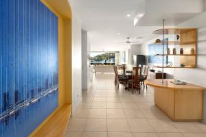 a kitchen and dining room with a large window at Pavillions 17 Waterfront with Private Pool and Buggy in Hamilton Island