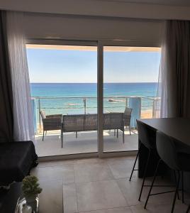 a living room with a view of the ocean at Stegna Sea & Sun in Archangelos