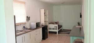 a kitchen with a sink and a counter top at Stay on the Bay in Gqeberha +7 photos