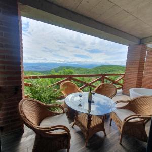 a table and chairs on a balcony with a view at Villa Vejini in Mamkoda