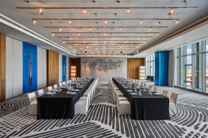 a conference room with long tables and white chairs at W Taipei in Taipei