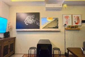 Typo House at Royal Residence في سورابايا: غرفة مع طاولة و كرسيين و تلفزيون