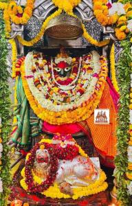 Una estatua de una deidad con muchas flores en Badrinath Govindghat Prithvi yatra hotels, en Badrīnāth