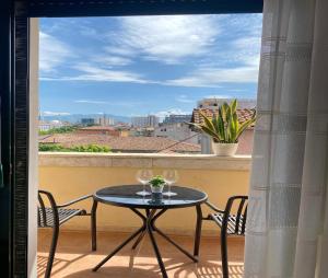 a table and chairs on a balcony with a view at Sol Apartment - 2 Bedrooms in Shkodër