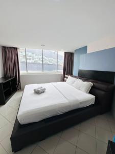 a large bed in a room with a large window at Your Hotel Klang in Klang