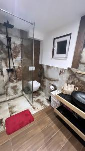 a bathroom with a shower with a toilet and a sink at Apartman Scepanovic 2 in Nikšić +35 photos