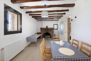 a dining room with a table and a fireplace at Mas Françó in Igualada