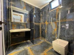 a bathroom with a shower and a toilet and a sink at Belek Tatil Villa in Belek