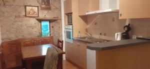 a kitchen with a counter and a table in it at Manoir de la Foulerie in Ancteville