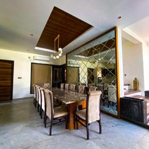 a dining room with a table and chairs at A Creation Farm Stay in Shamshabad