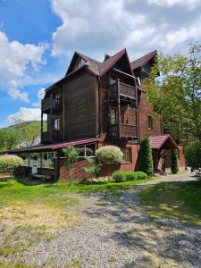 a large wooden house with a large yard at Бавор in Yaremche