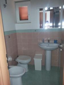 a bathroom with a sink and a toilet and a mirror at Casa vista mare in San Nicola Arcella +67 photos