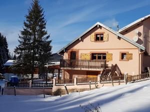 a large house with a balcony in the snow at gite cocoon neuf proche GERARDMER in Vienville