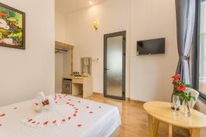 a room with a white table with roses on it at Thuong Trang Villa Phu Quoc in Phu Quoc
