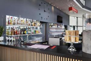 a bar in a restaurant with a lot of alcohol at Aiden by Best Western Skavsta Airport in Nyköping