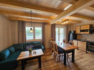 ein Wohnzimmer mit einem grünen Sofa und einem Tisch in der Unterkunft Kominkówka in Brenna
