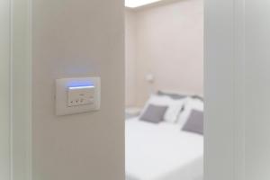a bedroom with a bed and a light switch at Tom Luxury Home in Fondi