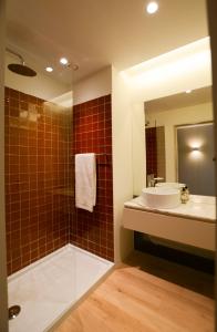 a bathroom with a tub and a sink and a mirror at Quinta do Fundo in Mondim de Basto