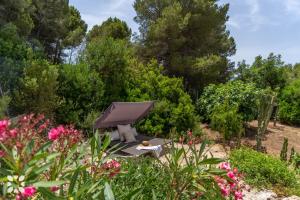a barbecue in a garden with pink flowers at Villa Corasol by Abahana Villas in Teulada