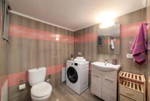 uma casa de banho com um WC e uma máquina de lavar roupa em Loft 57 em Agios Nikolaos