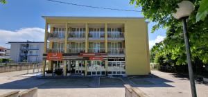 a building with a store in front of it at Hotel Giallo in Noceto