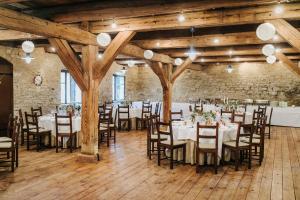 a room with tables and chairs in a building at Hotel Burg Wanzleben in Wanzleben