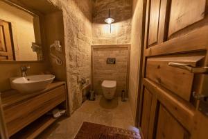 a small bathroom with a sink and a toilet at Feris Cave Hotel in Nevsehir