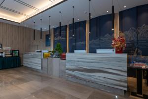 a lobby with a reception desk in a building at Morning Hotel, Poyang Sports Center in Boyang