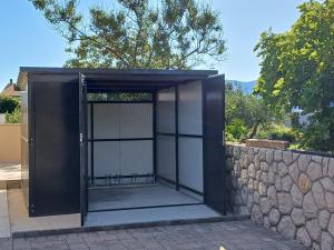 an open door into a building with a stone wall at Villa Muskatel -with heated pool in Krk