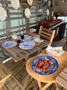 a wooden table with plates of food on it at Mimosa Village - Turismo de Natureza in Mortágua
